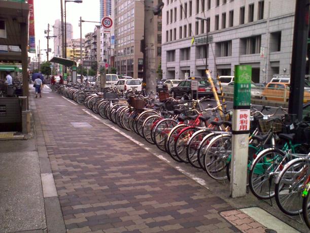 A bicycle park in front of a supermarket